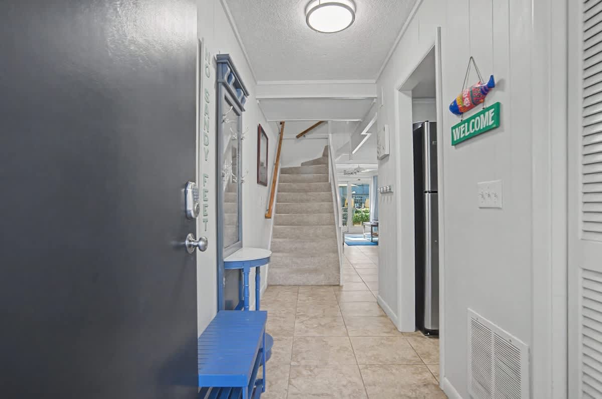 Step into your welcoming hallway, where bright coastal vibes and thoughtful touches create an instant sense of home.