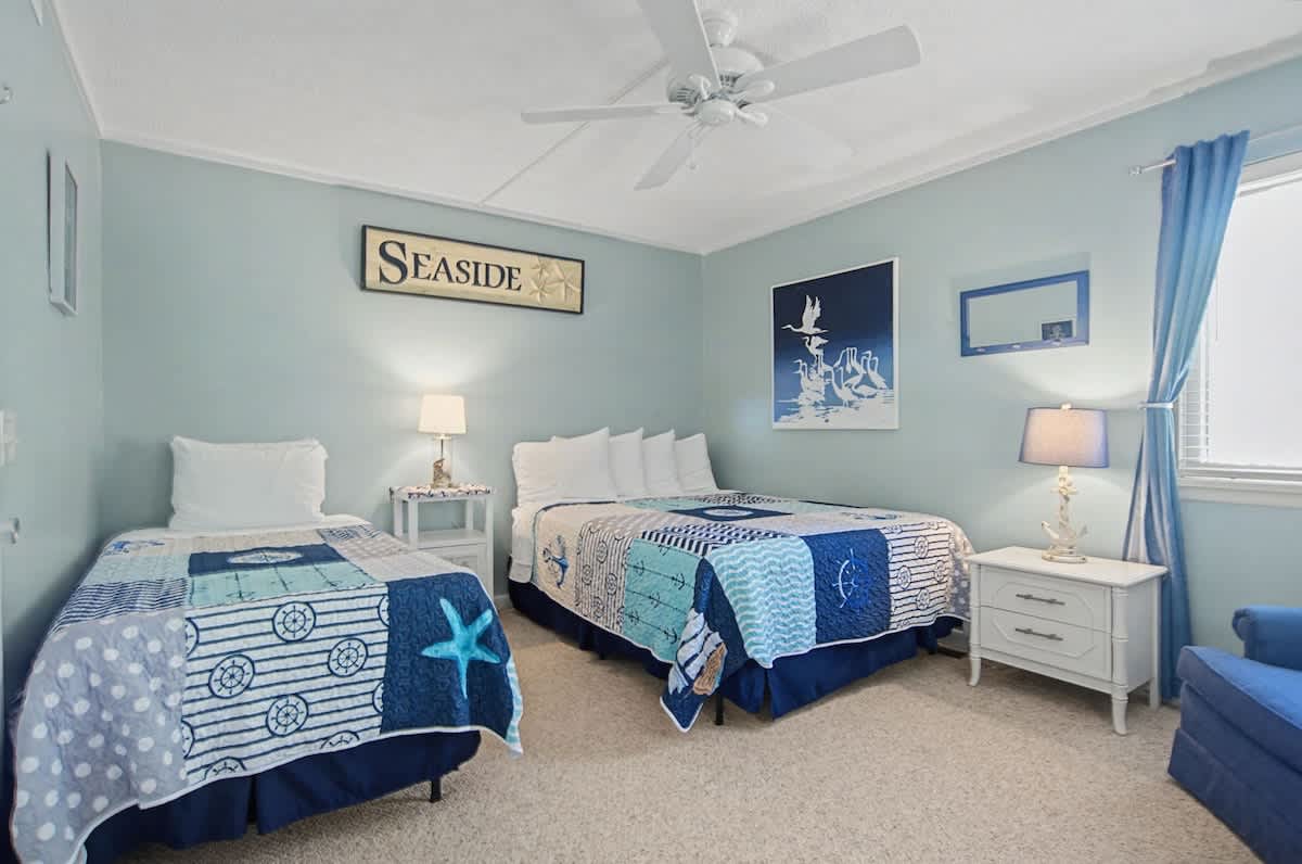 Perfect for guests, this inviting bedroom features both a queen and twin bed, offering flexible sleeping arrangements and a cozy retreat to recharge after a day of island adventures.
