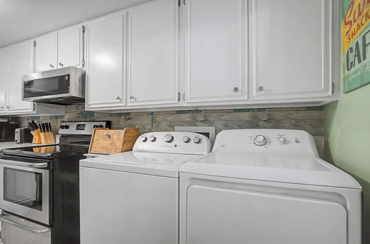 Convenient laundry area offers ample cabinet storage for your convenience.