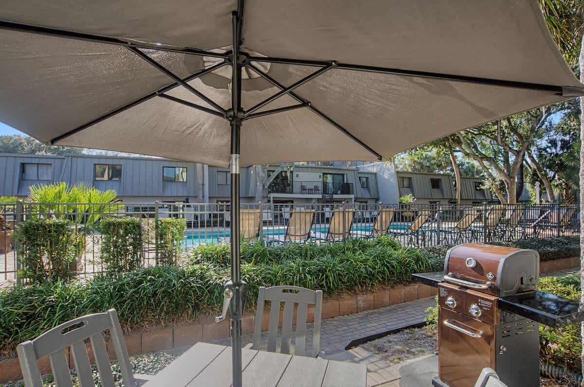 Fire up the grill under your private umbrella while enjoying pool views and tropical landscaping in your dedicated BBQ area.