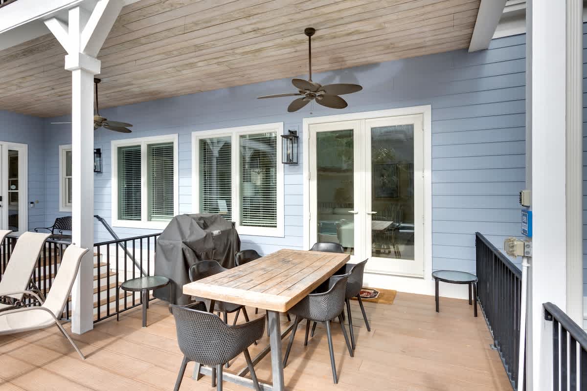 Unwind on your private covered deck with dining space, ceiling fans, and peaceful views through French doors.