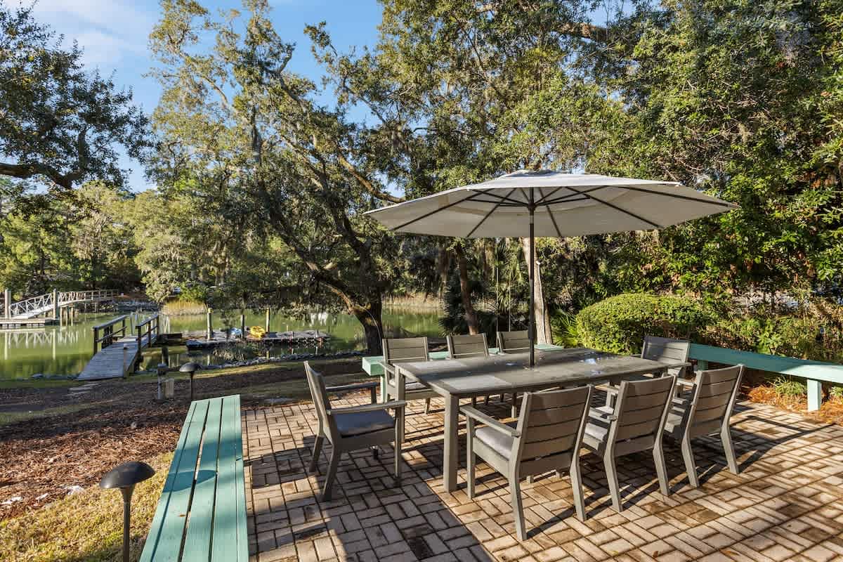 Waterfront dining with private dock access surrounded by mature trees and peaceful lake views.
