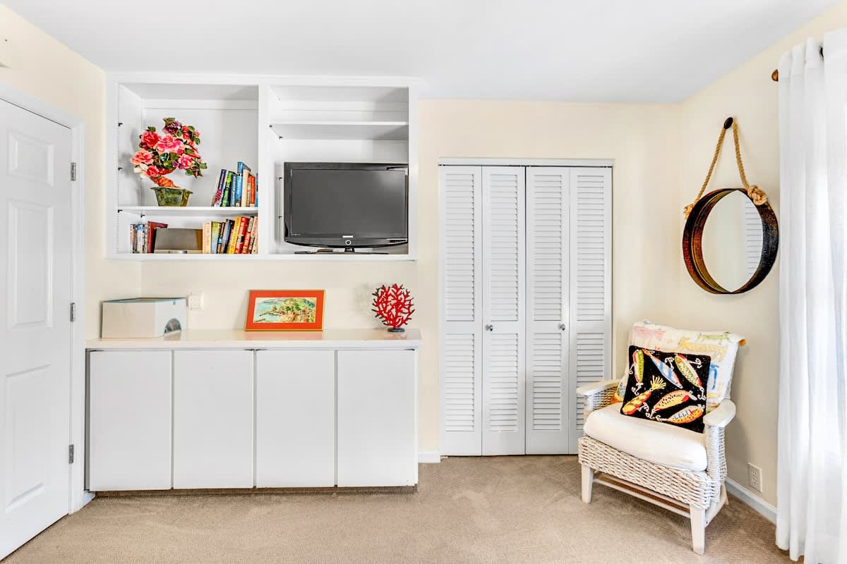 Unwind in your bright coastal retreat with built-in entertainment center, cozy reading nook, and charming nautical touches.