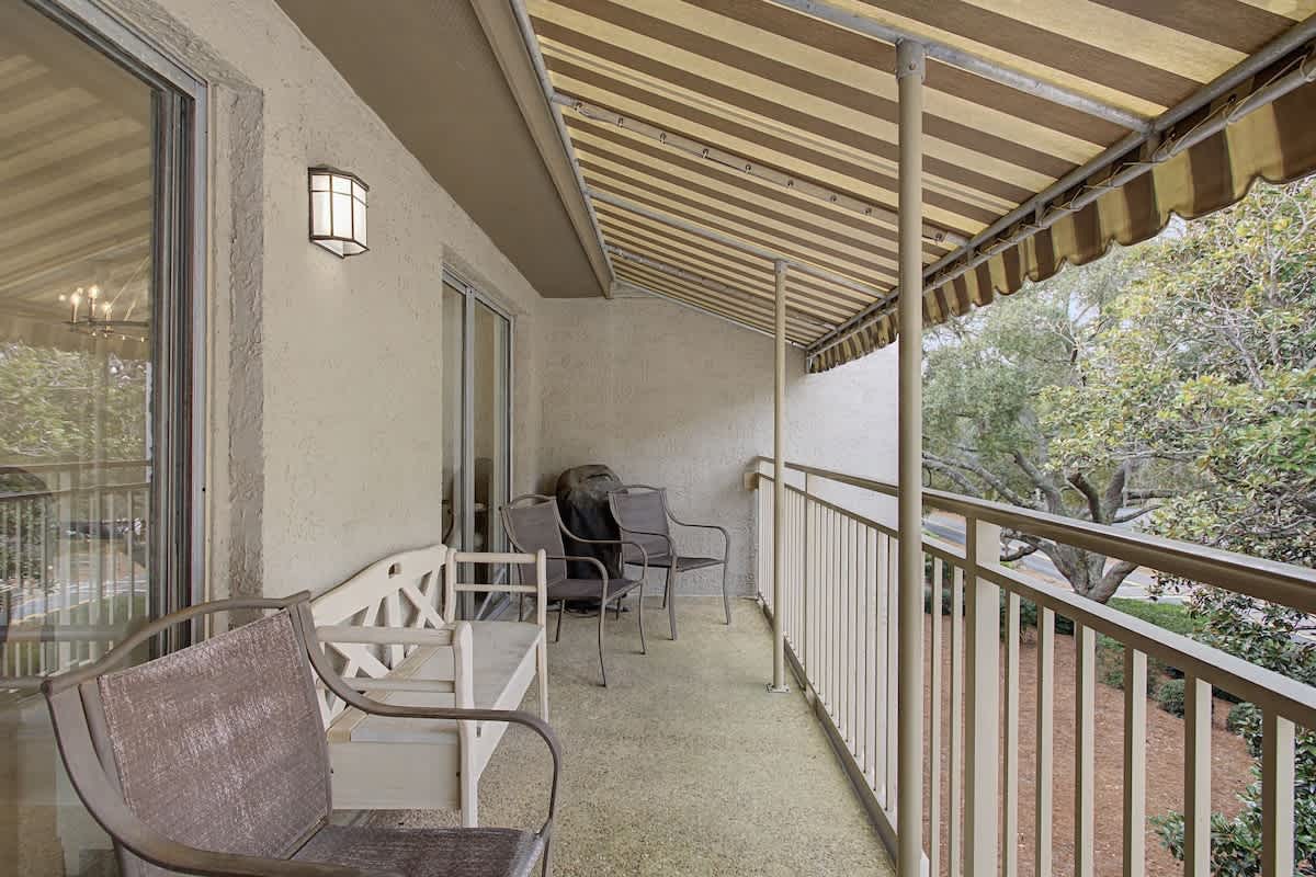 Relax on your private covered balcony with comfortable seating, perfect for morning coffee or evening unwind time.