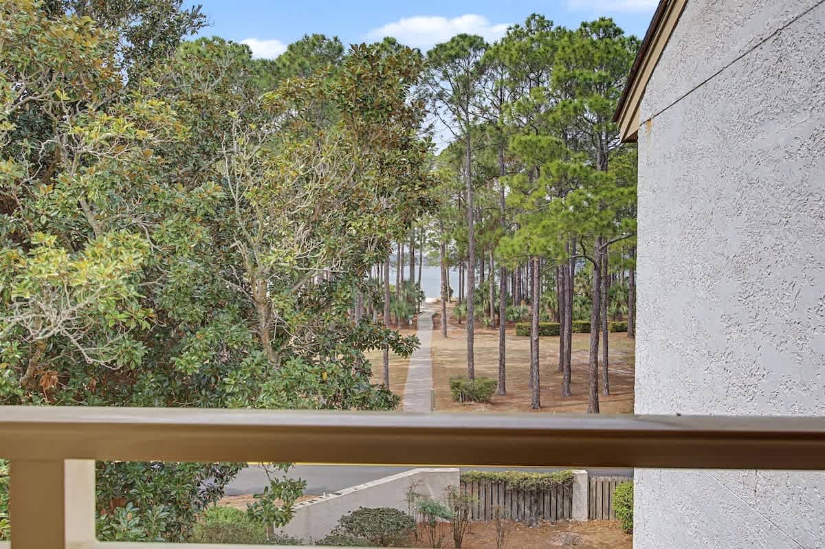 Peaceful wooded view from your private balcony overlooks tall pines and natural landscape, perfect for morning coffee moments.