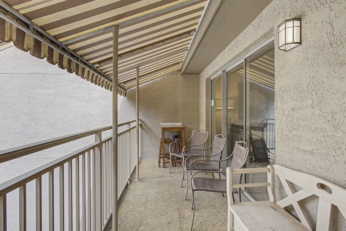 Unwind on your private covered balcony with comfortable seating and peaceful atmosphere.