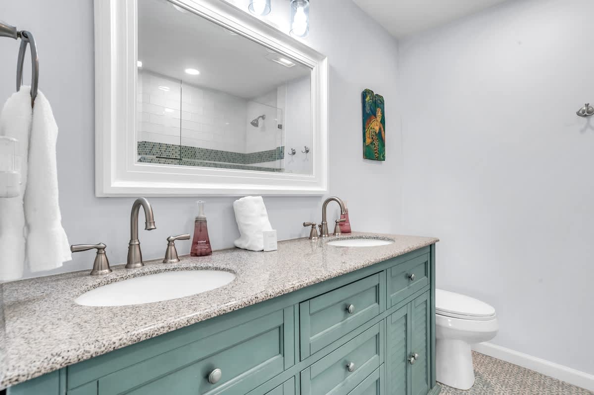 Fresh towels and dual vanities make your morning routine effortless in this bright, spa-like bathroom with modern finishes.