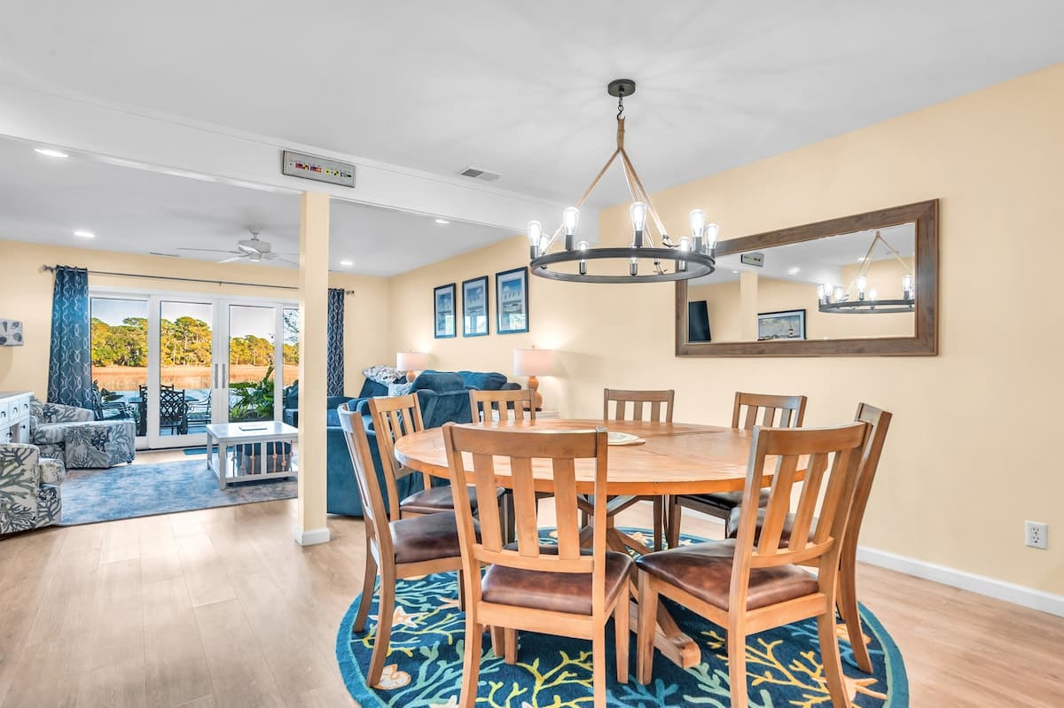 Gather around your elegant dining table for memorable meals, with modern lighting creating the perfect ambiance for family dinners.