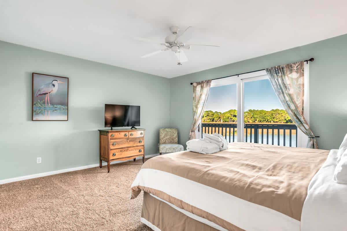 Wake up to stunning water views from your peaceful bedroom, where soft morning light and soothing colors create the perfect retreat.
