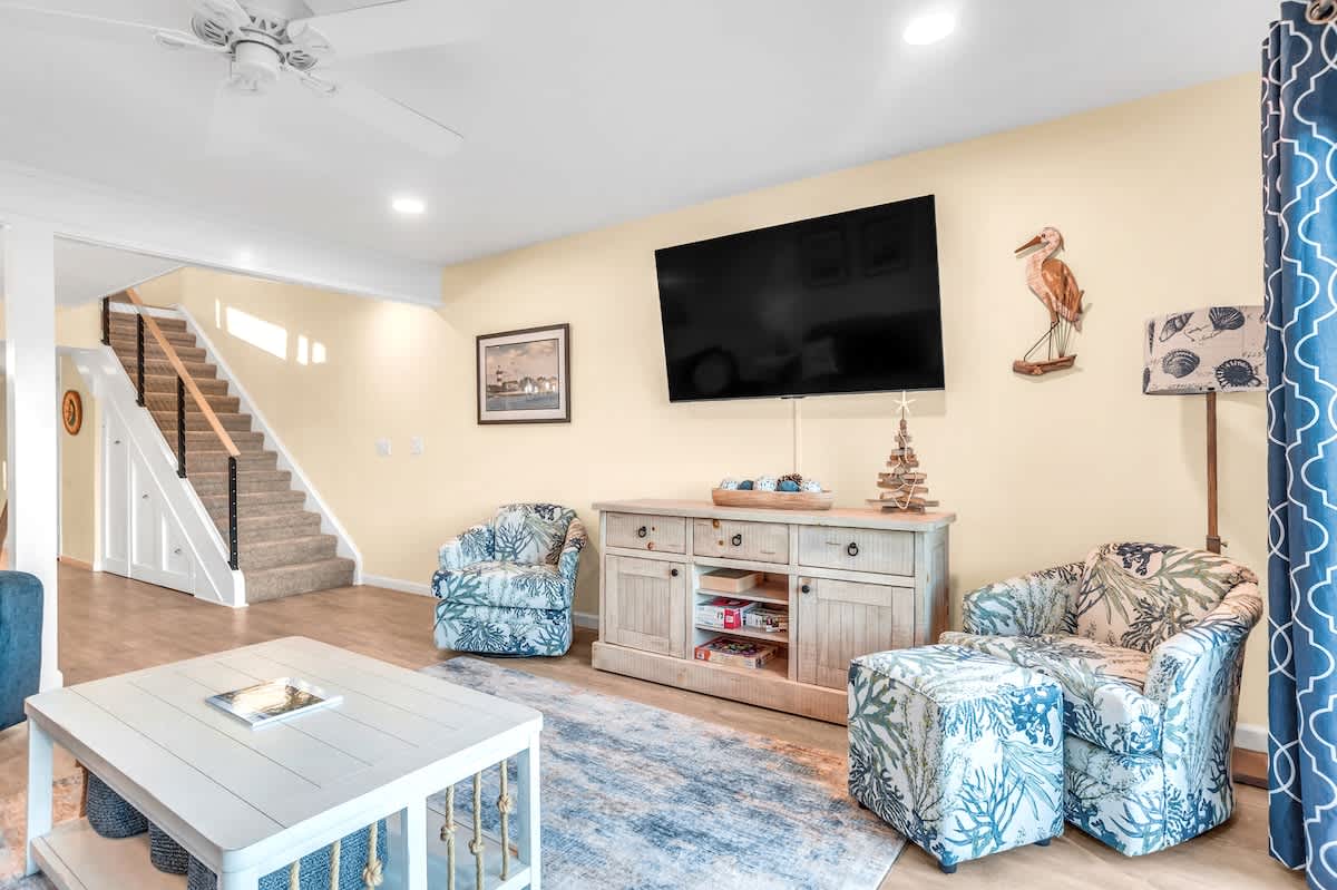 Sink into coastal charm in your beautifully appointed living room, where nautical touches and comfy seating create the perfect retreat.