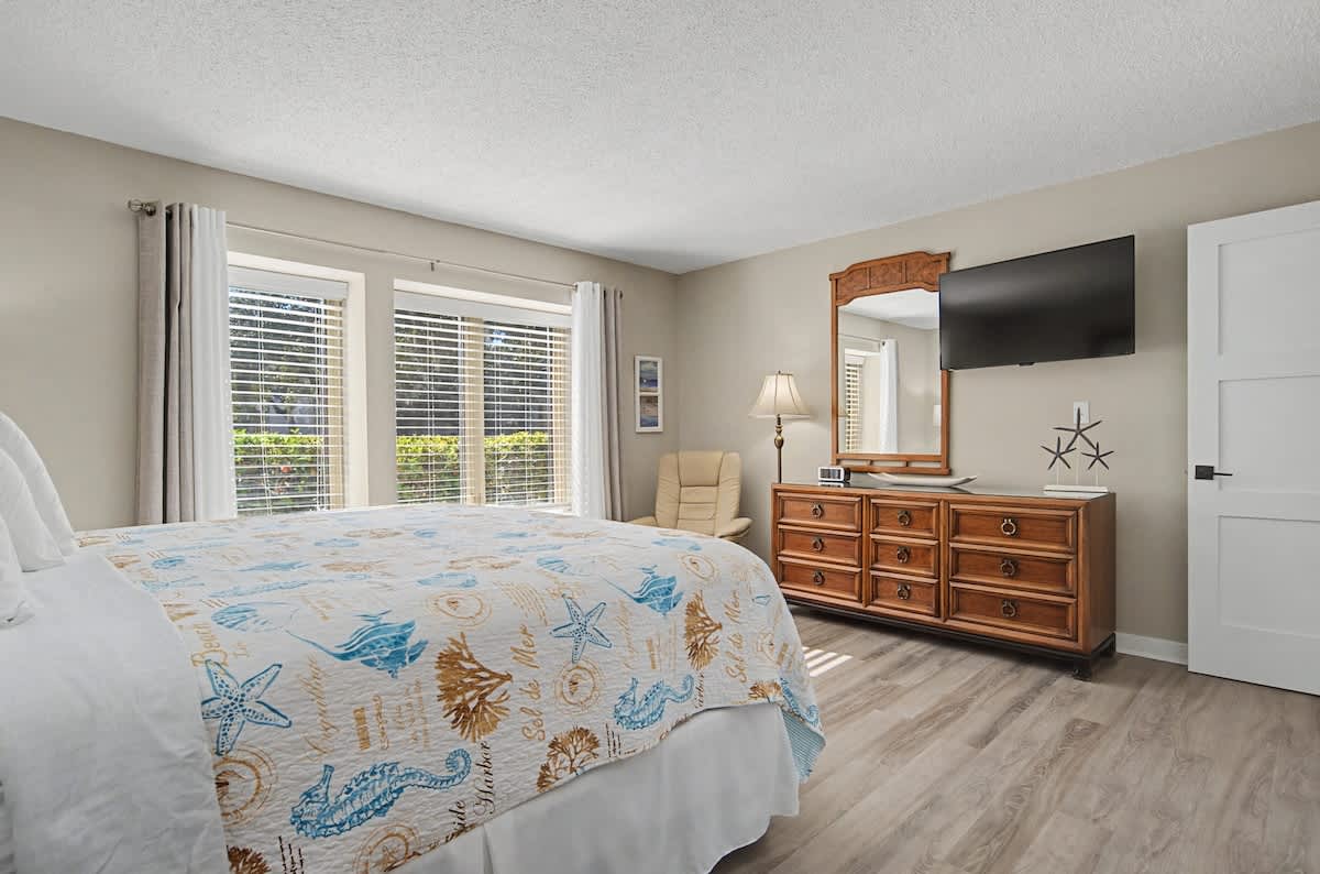 Drift off to sleep in your coastal-themed bedroom, where ocean-inspired decor and warm wood furnishings create the perfect seaside retreat.