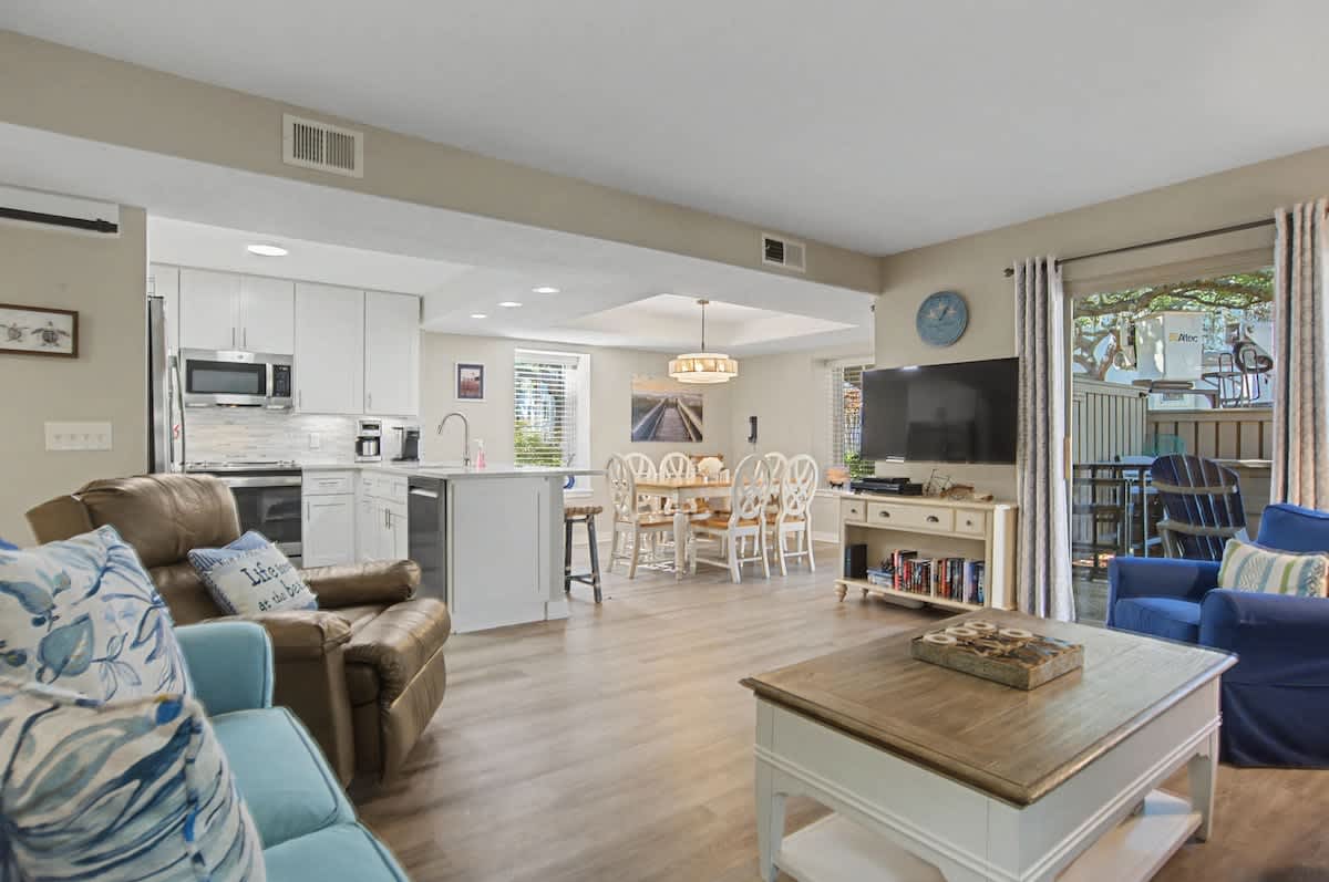 Relax in your open-concept haven where coastal blues meet warm neutrals, creating the perfect flow from kitchen to living space.