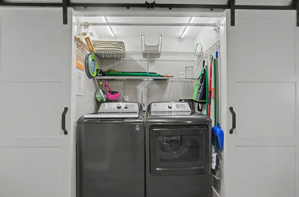 Your dedicated laundry closet keeps clothes fresh with full-size washer and dryer, plus organized storage for all your cleaning essentials.
