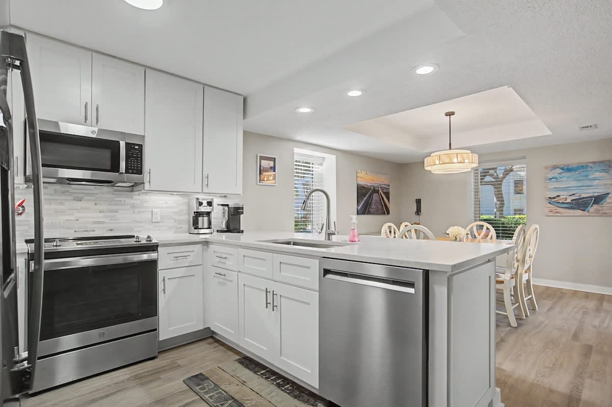 Your fully equipped kitchen features modern appliances and a convenient island for cooking and dining together.