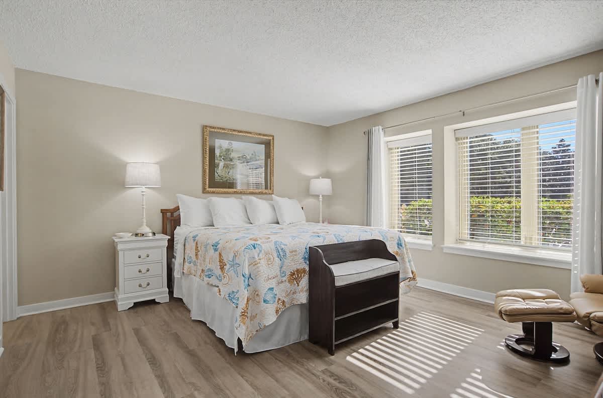 Drift off to sleep in this peaceful bedroom where soft linens and gentle sunlight create your perfect retreat.
