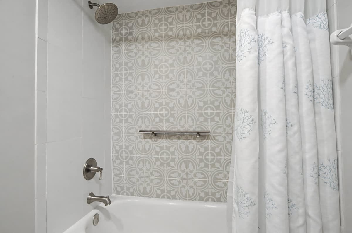 Refresh in your elegant bathroom with beautiful patterned accent tiles and a deep soaking tub perfect for unwinding after exploring.