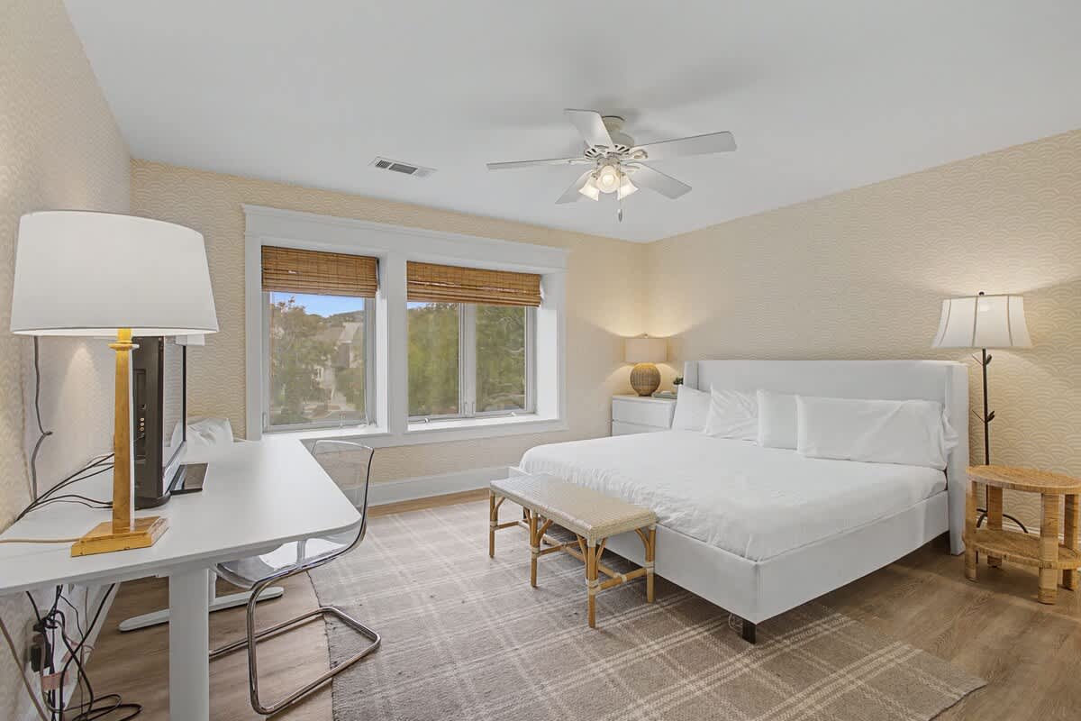 Rest peacefully in your bright bedroom with crisp linens and garden views from dual windows.
