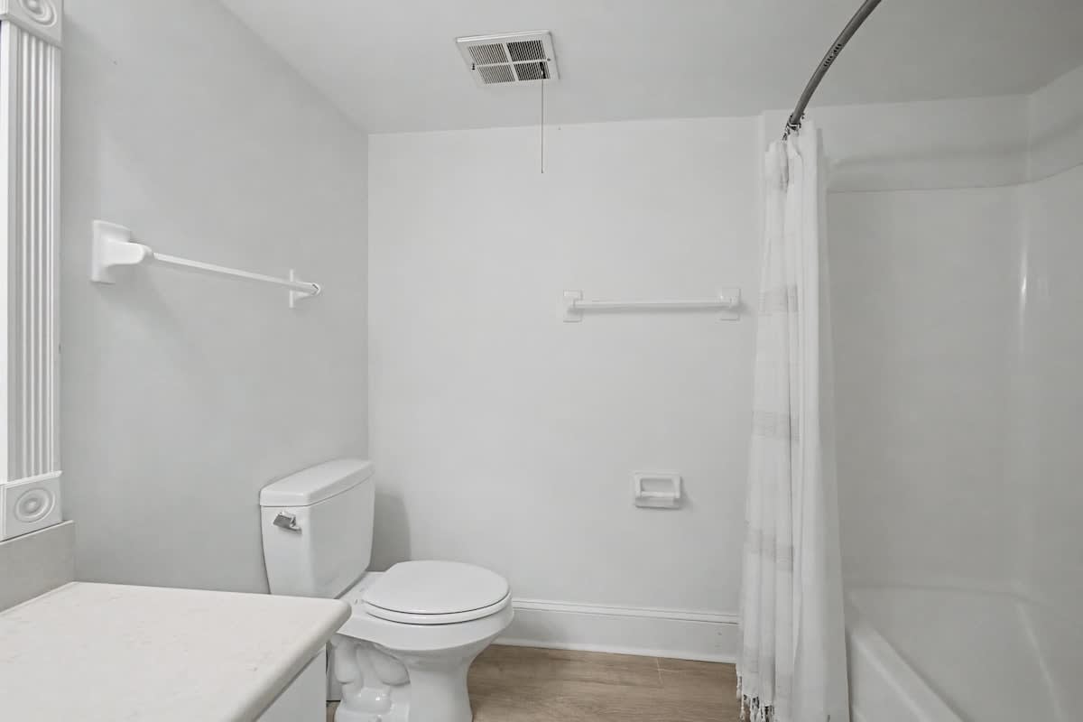 Your spotless bathroom features a spacious tub-shower combo with accessibility rails for comfort and safety.