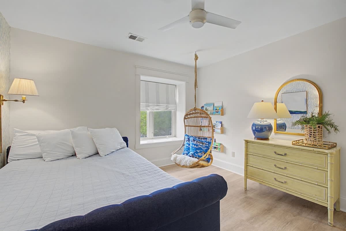 Unwind in your serene bedroom featuring a cozy reading nook and charming coastal touches that create the perfect retreat.