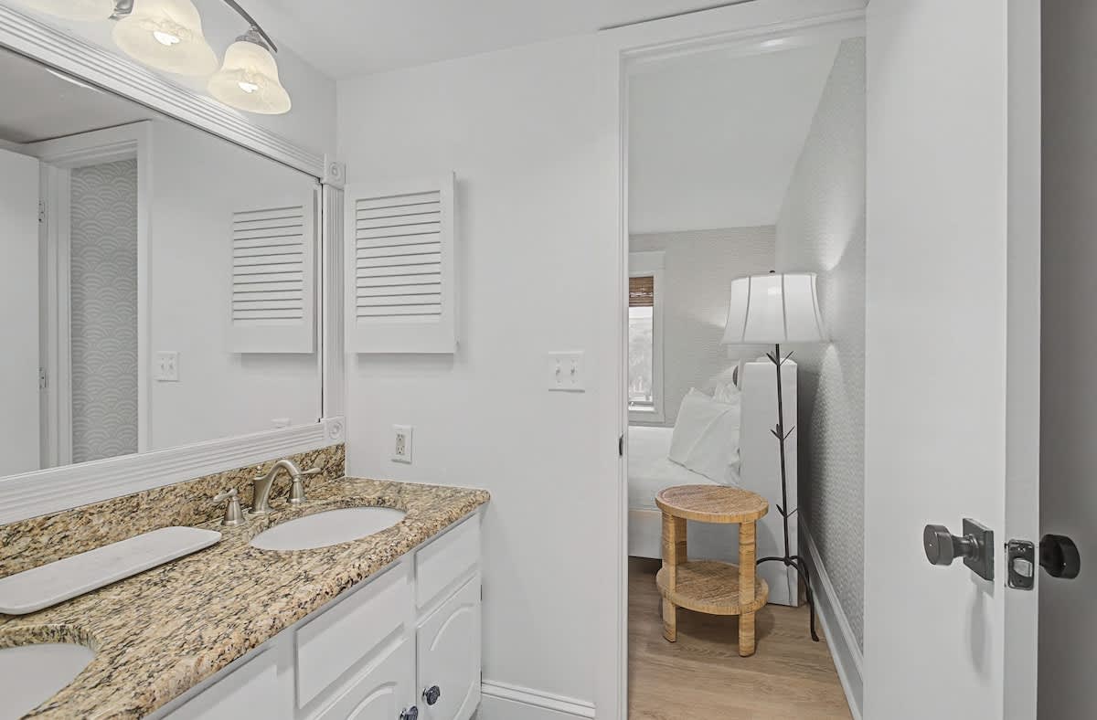 Your pristine bathroom features granite countertops and thoughtful lighting, creating a spa-like sanctuary for your daily routine.