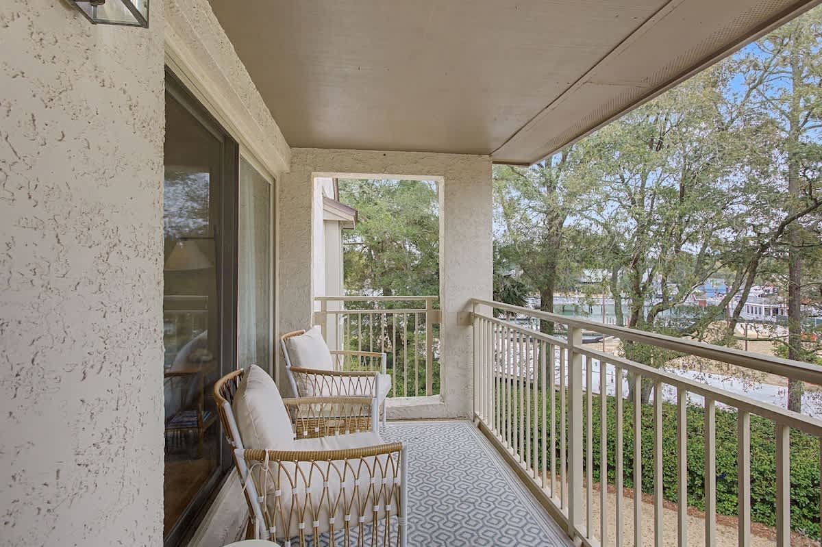 Unwind on your private covered balcony with comfortable wicker seating overlooking leafy neighborhood views.