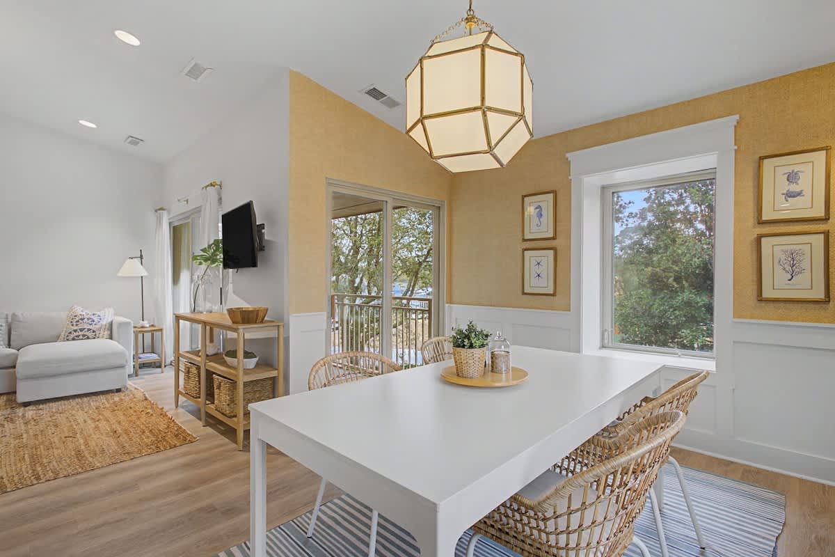Gather around your bright dining table where natural light streams through windows, creating the perfect spot for morning coffee and shared meals.