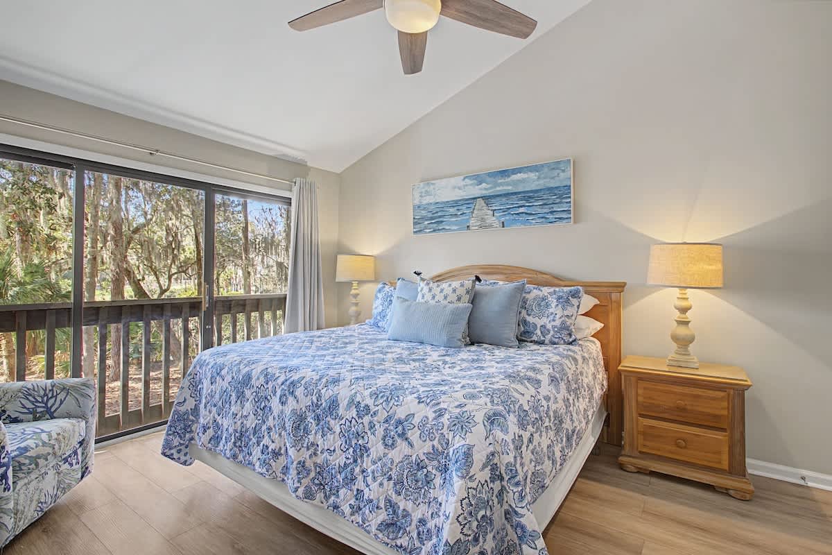 Drift off to peaceful sleep in your serene retreat, where soft blue linens and warm lighting create the perfect sanctuary.