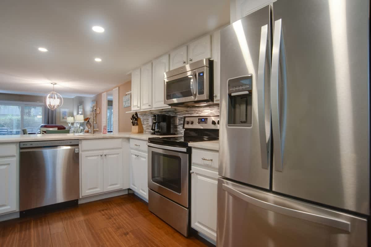 Your fully equipped kitchen sparkles with stainless steel appliances and sleek white cabinets, perfect for creating memorable meals during your stay.