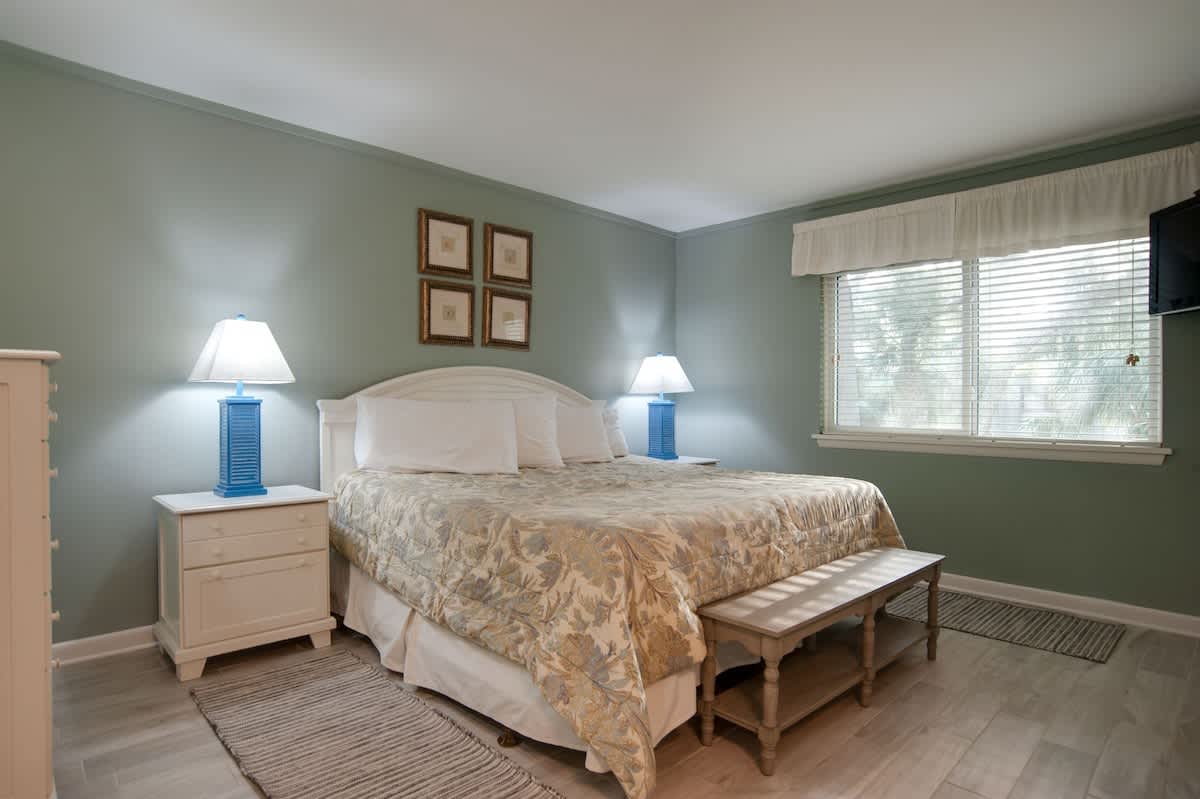 Drift into peaceful dreams in your serene bedroom, where soft sage walls and coastal touches create the perfect sanctuary for rest.