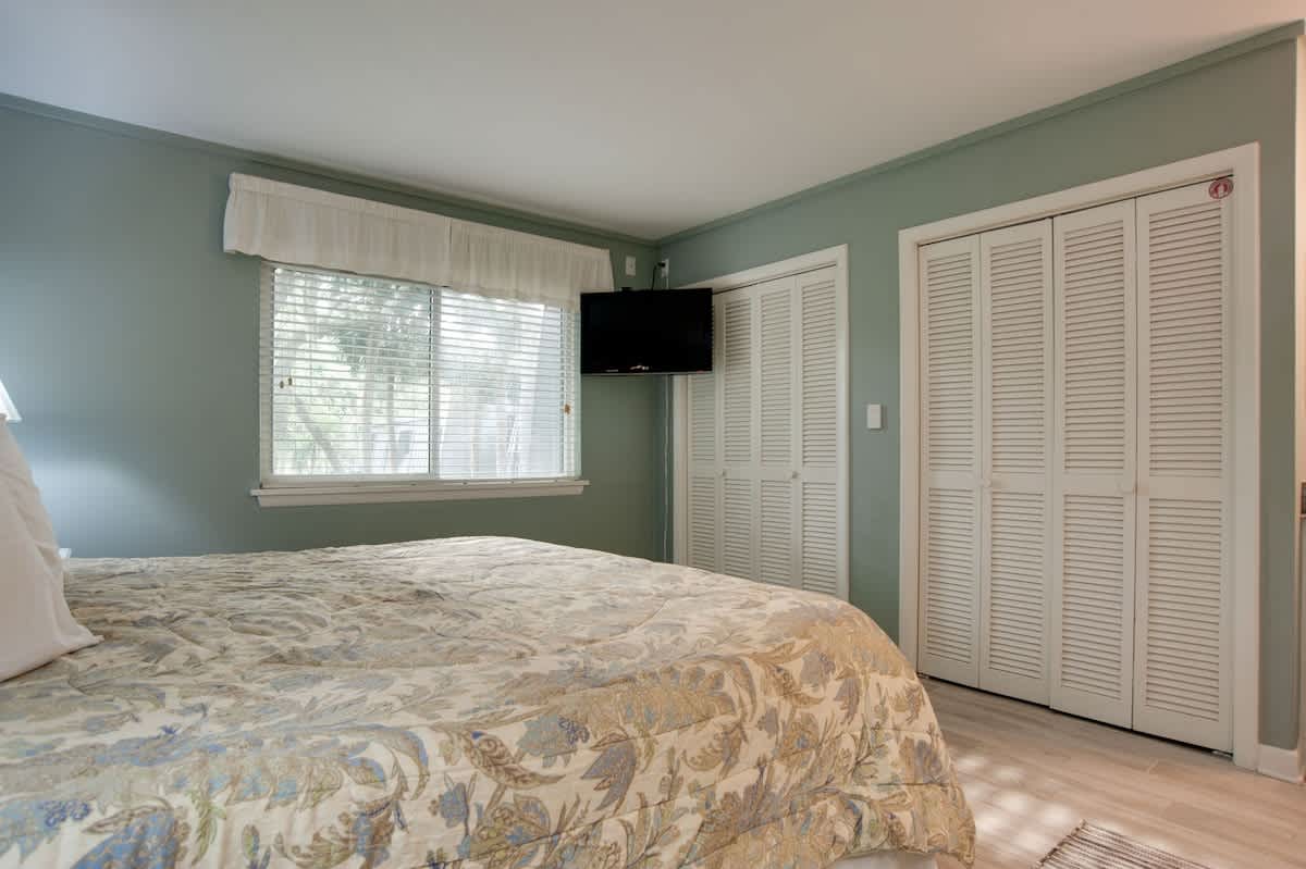Relax in your peaceful bedroom with soothing sage walls, ample closet space, and natural light streaming through your window.