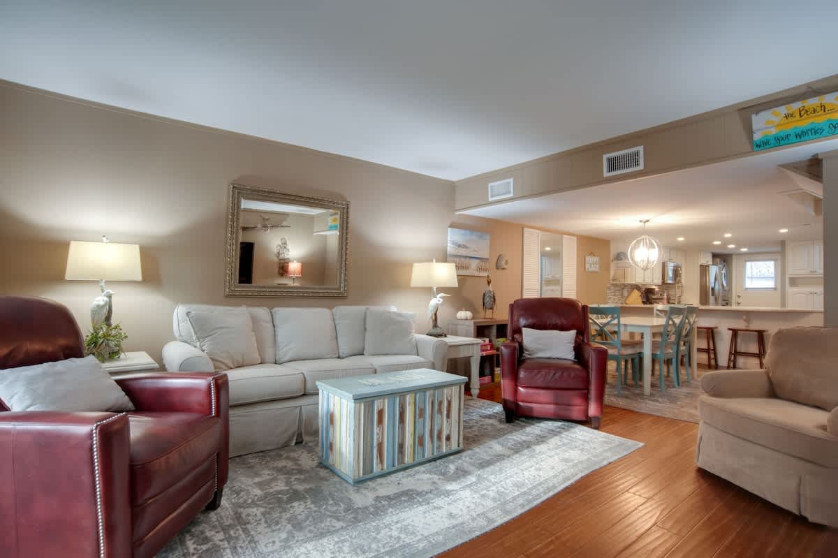 Sink into plush seating where warm lighting and rich leather create your perfect retreat for movie nights and morning coffee.
