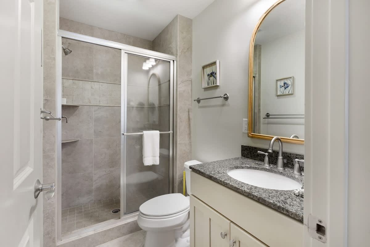 Step into your private bathroom sanctuary with elegant granite countertops, spacious walk-in shower, and thoughtful touches.