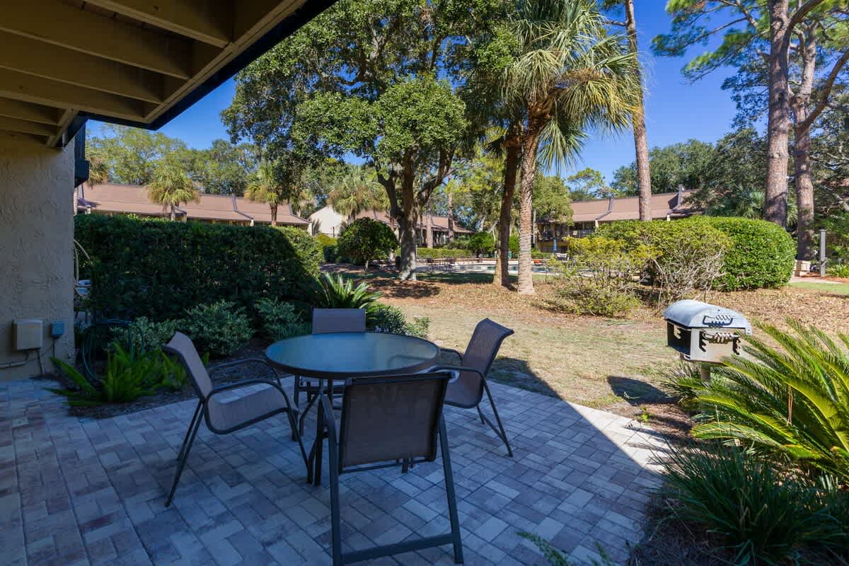 Your private patio offers peaceful dining surrounded by lush tropical landscaping, complete with BBQ grill for memorable outdoor meals.