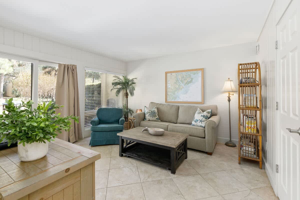 Sink into this bright living room where natural light streams through large windows, creating the perfect spot for your morning coffee or evening unwind.