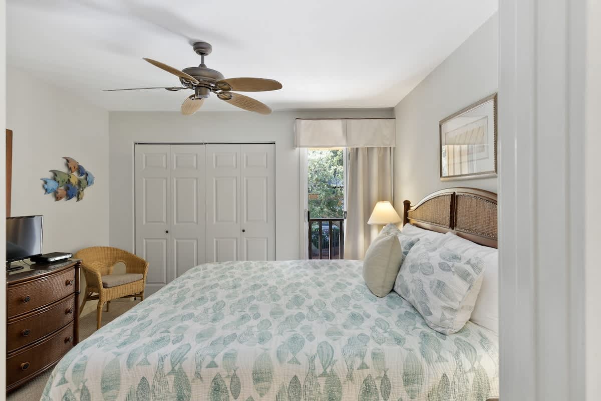 Drift off to sleep in your peaceful bedroom with coastal charm, complete with ceiling fan and garden views.