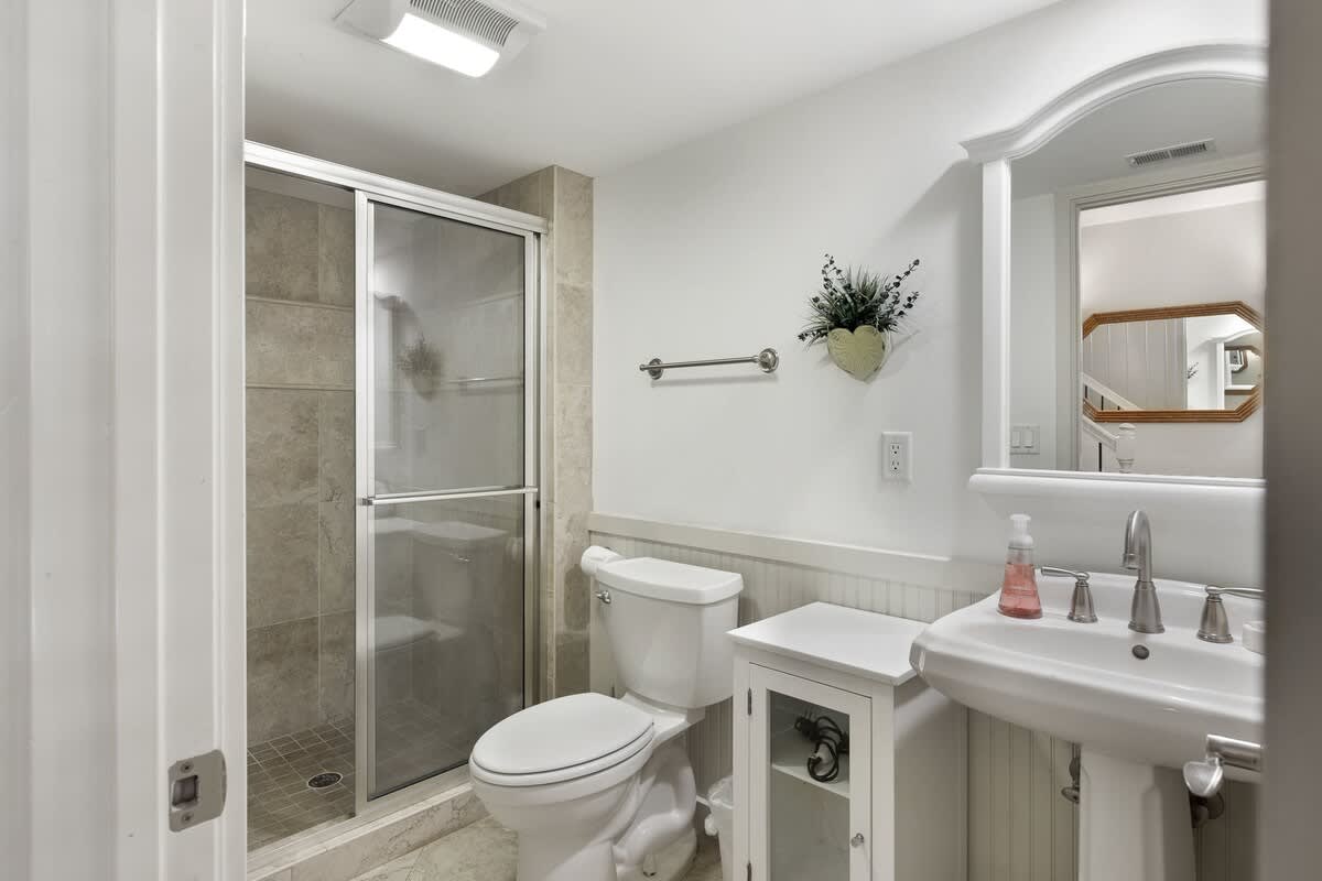 Step into your pristine bathroom featuring a spacious walk-in shower, elegant fixtures, and thoughtful touches that make your stay comfortable.