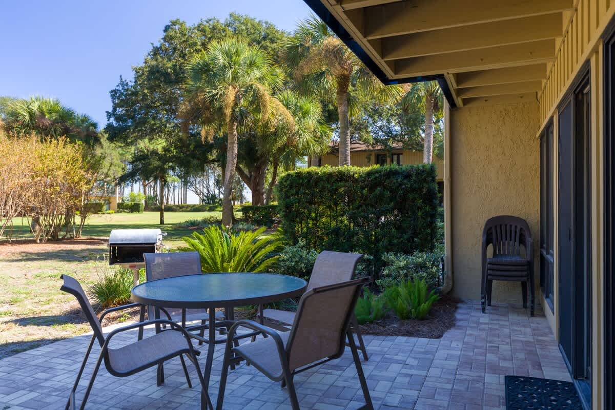 Relax at your private patio table surrounded by lush palm trees and peaceful garden views—perfect for morning coffee or evening conversations.