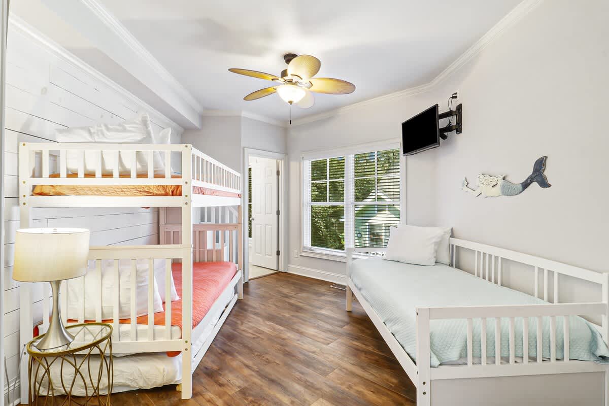 Your kids will love sharing this bright bedroom with cozy bunk beds and twin bed, plus TV entertainment for movie nights together.