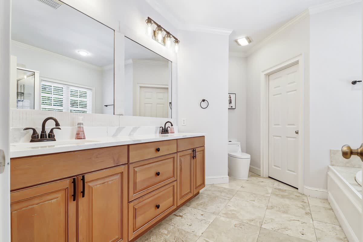 Your spacious bathroom features double vanities and marble countertops, perfect for your morning routine in elegant comfort.
