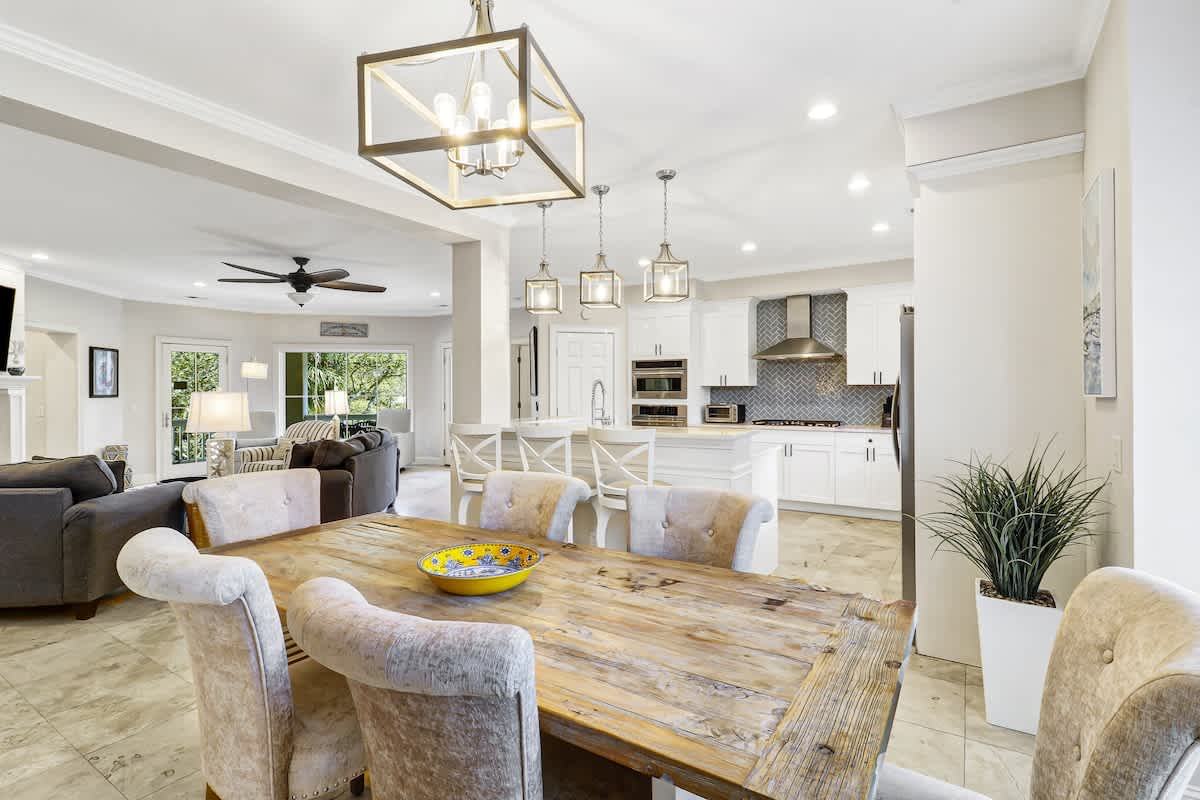 Gather around your beautiful dining table where elegant pendant lights create perfect ambiance for memorable meals with loved ones.