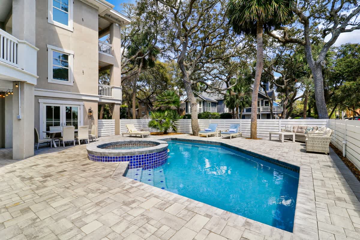 Dive into your private oasis with a sparkling pool and relaxing spa, surrounded by tropical palms and comfortable lounging areas.