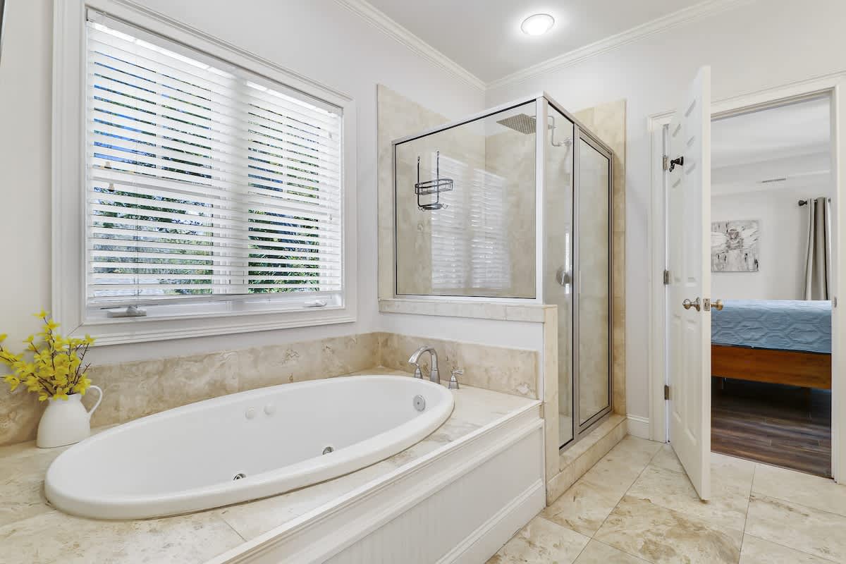 Unwind in your spa-like en-suite with a luxurious soaking tub and separate glass shower, all bathed in natural light.