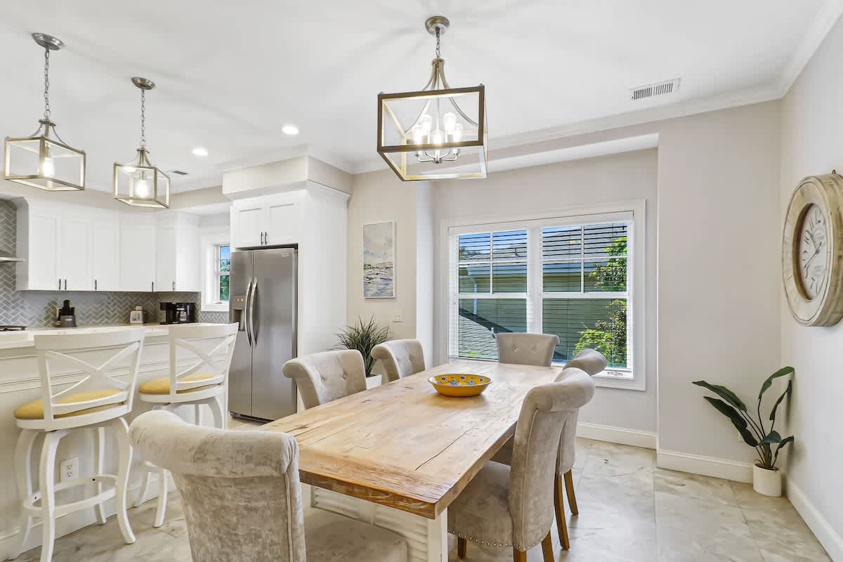 Gather around your elegant dining table where warm wood meets soft textures, creating the perfect space for memorable meals together.