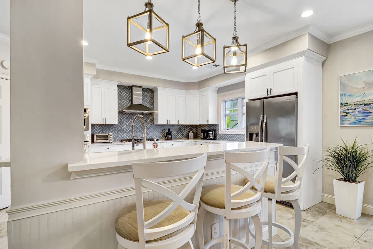 Your gourmet kitchen sparkles with sleek appliances, elegant pendant lighting, and a spacious island perfect for morning coffee or evening entertaining.