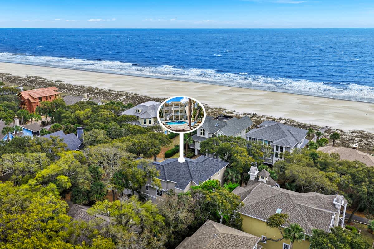 2nd row vacation rental highlighted with swimming pool, nestled among coastal homes just steps from pristine sandy shores and ocean waves.