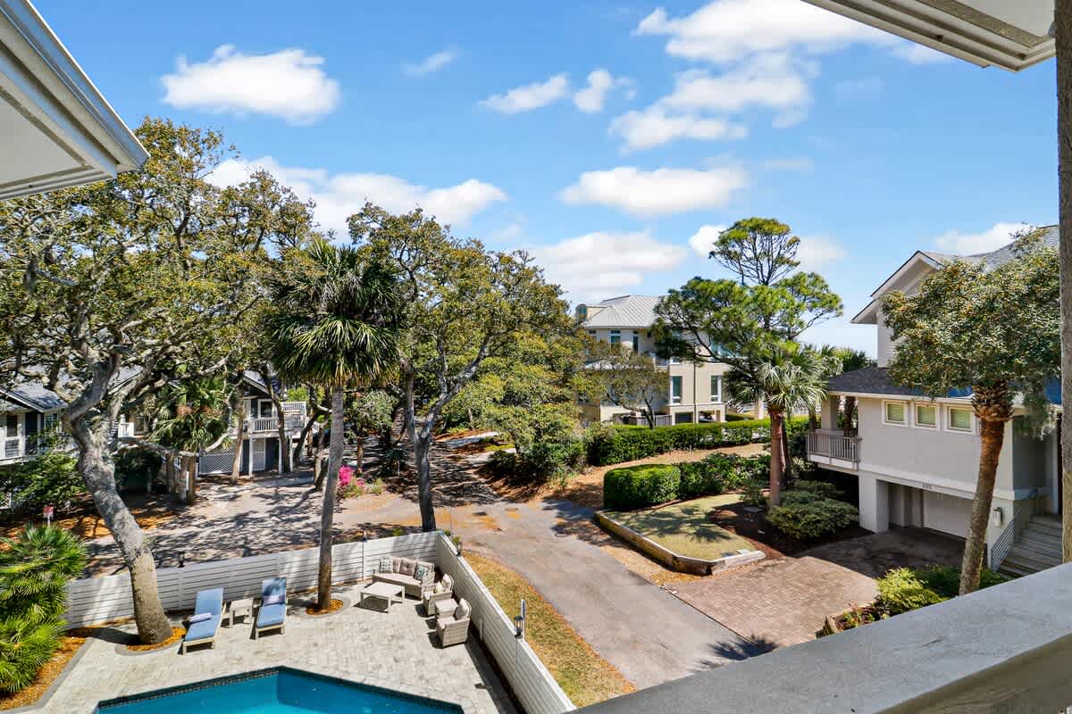 Elevated view of a peaceful residential community with tropical landscaping and charming neighborhood homes.