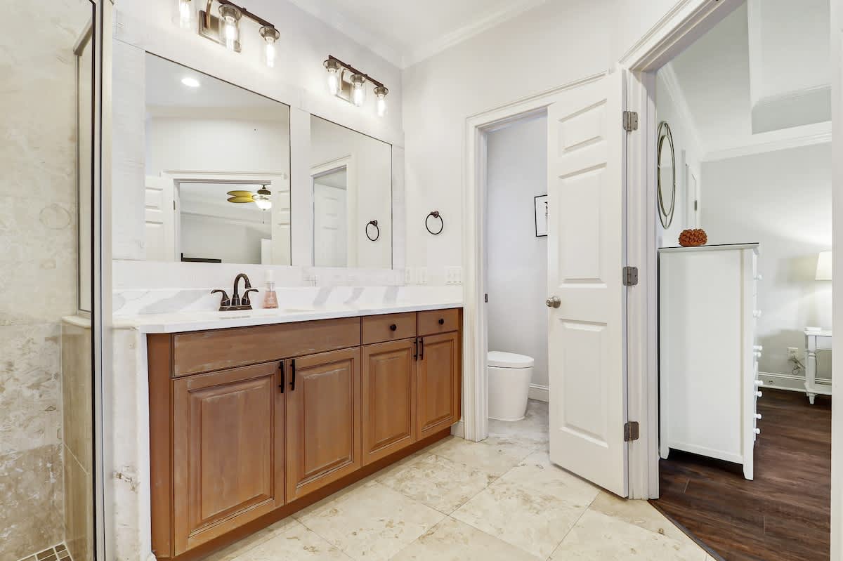 Spacious master bathroom with dual vanities and marble countertops offers plenty of room to get ready for your day.