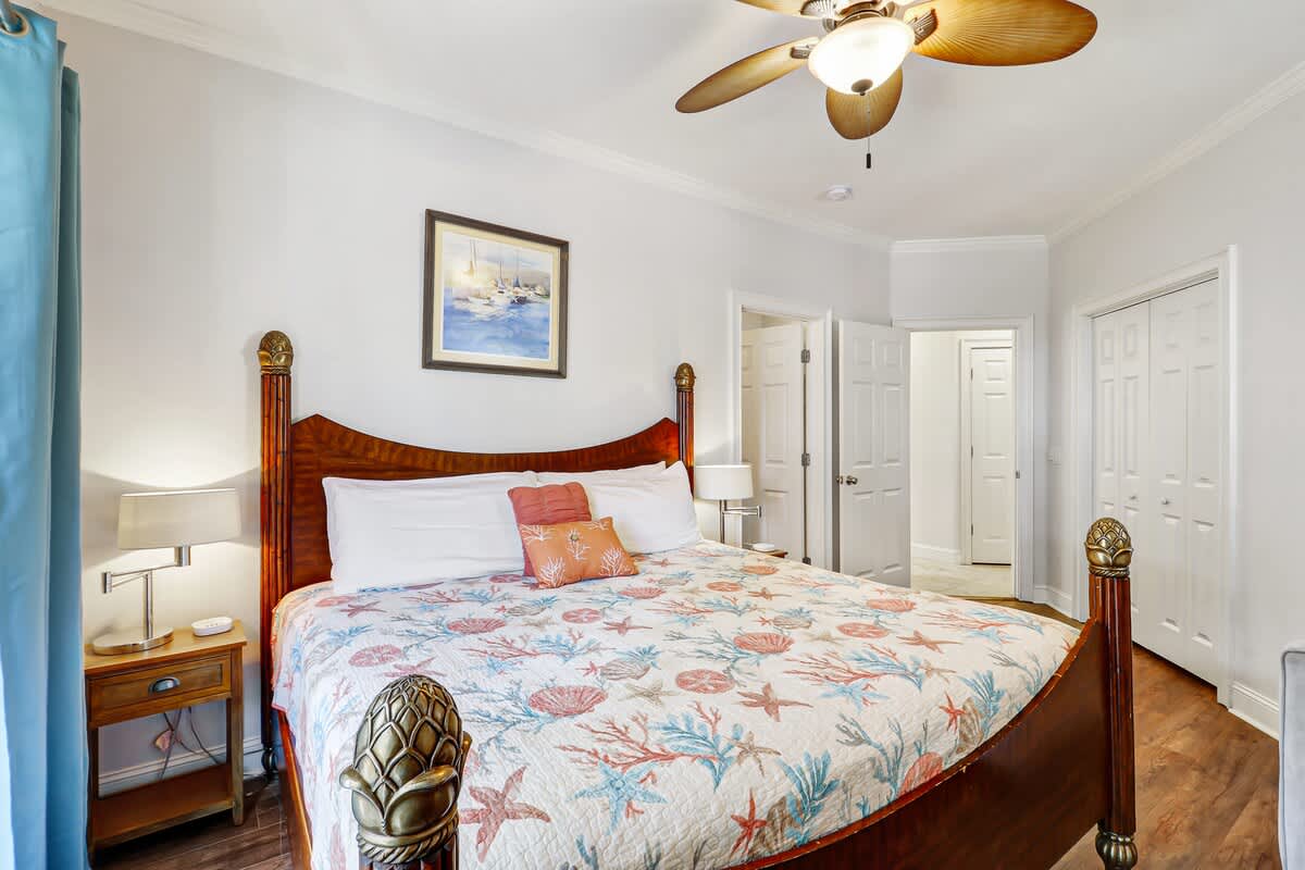 Inviting guest bedroom featuring a king bed and a twin sleeper loveseat, offering a comfortable and flexible space perfect for both relaxation and additional sleeping.