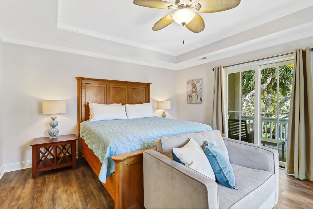 Drift into peaceful slumber in your elegant bedroom, where warm wood tones meet coastal charm and palm tree views create your perfect retreat.