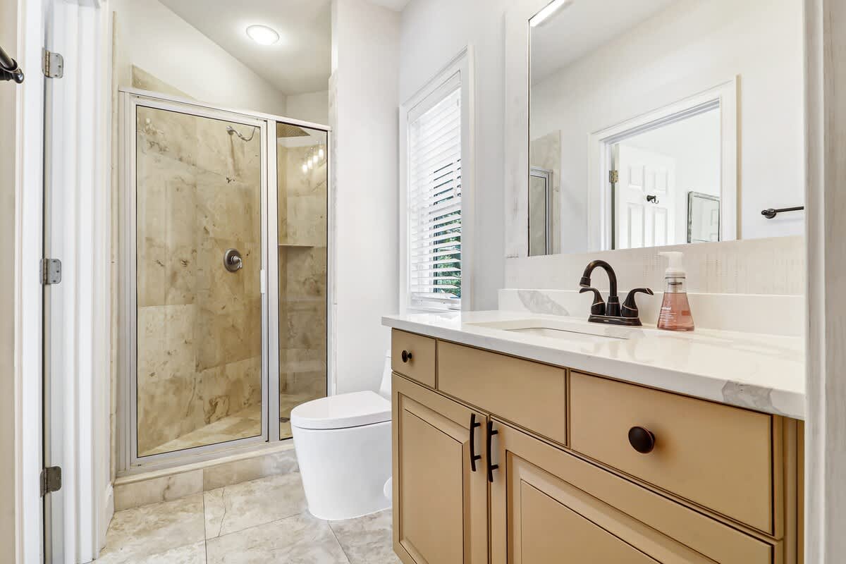 Step into your private spa-like bathroom featuring marble tile, spacious walk-in shower, and elegant vanity for morning rituals.
